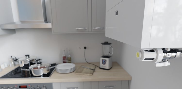 Detailansicht eines Sicherheitsventils an einem Untertischgerät in einer modernen Küche mit Herd und hölzerner Arbeitsplatte.