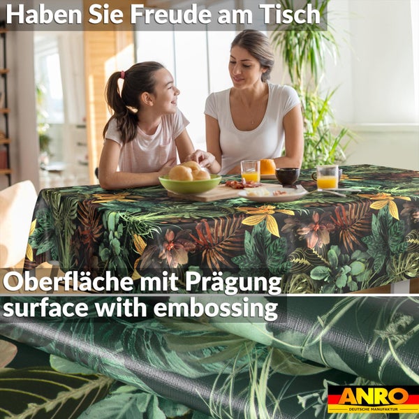 Abwischbare Tischdecke mit tropischem Blättermuster und geprägter Oberfläche, zwei Personen am gedeckten Tisch, ANRO Logo.