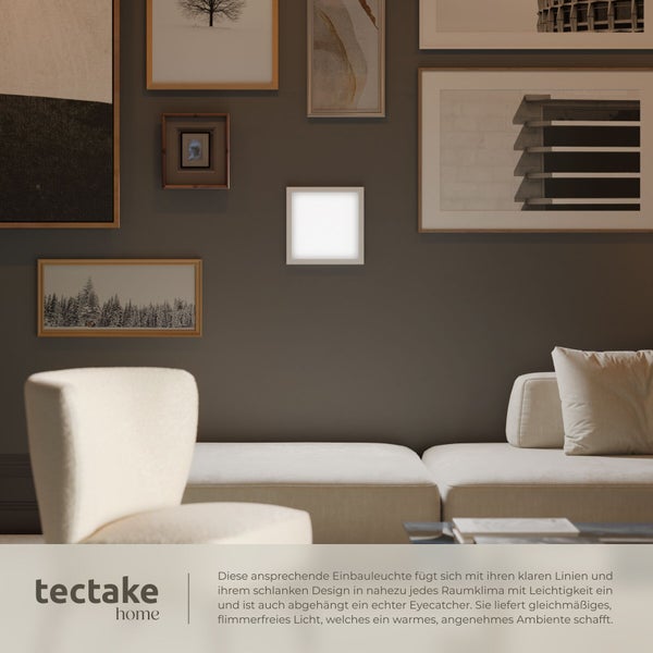 Quadratische LED Einbauleuchte an einer Wand mit Bildergalerie in einem modern eingerichteten Wohnzimmer mit Sofa.