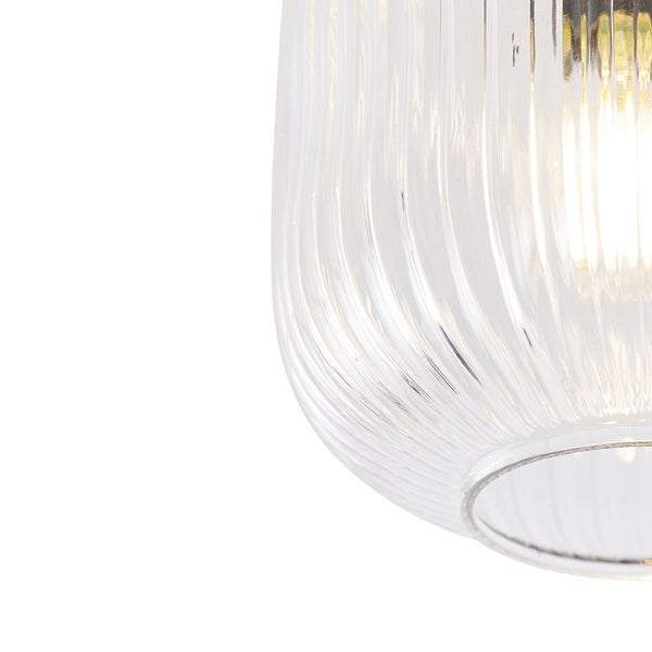 Detailansicht einer klaren Glaslampe mit gerippter Oberfläche.