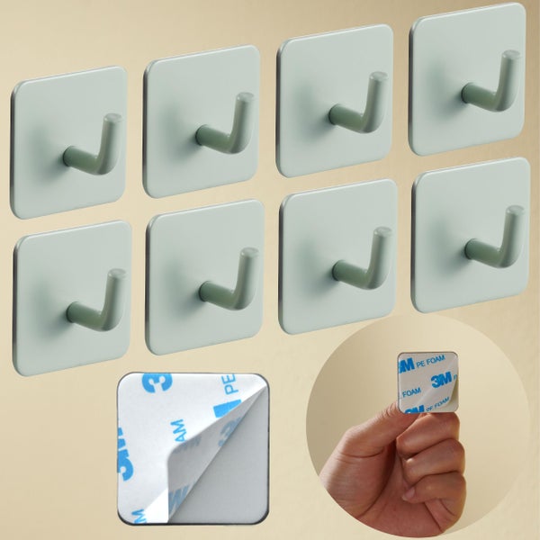 Set von acht selbstklebenden Wandhaken mit quadratischer Basis und Detailansicht der Kleberückseite mit 3M Logo.