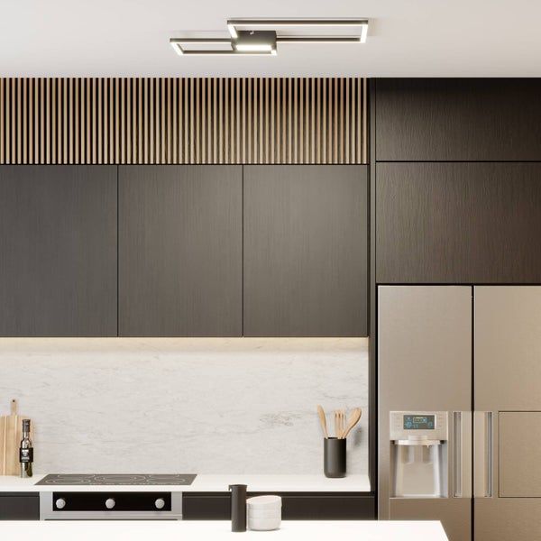 Moderne Küche mit geometrischer LED-Deckenleuchte, dunklen Fronten, Holzpaneelen und Marmorrückwand.