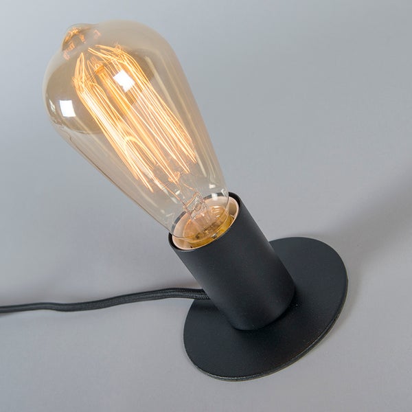 Vintage Tischleuchte mit schwarzem Metallsockel und leuchtender LED-Filament-Glühbirne in Bernsteinoptik.