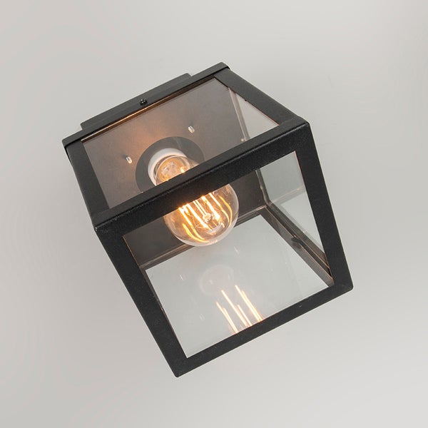 Würfelförmige Außenwandleuchte aus schwarzem Metall und klarem Glas mit leuchtender LED-Filamentlampe.