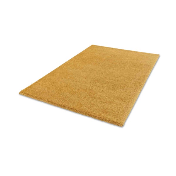 Rechteckiger Hochflor-Teppich in Senfgelb mit weicher Oberfläche.