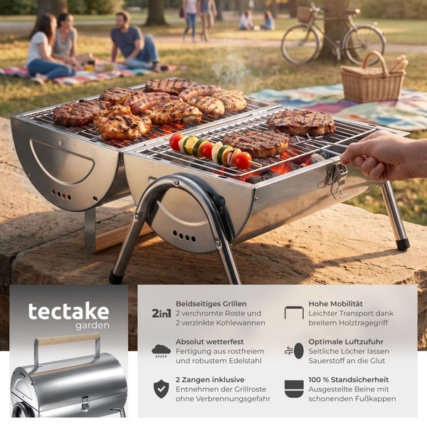 Mobiler Holzkohlegrill aus Edelstahl von tectake garden, aufgeklappt beim Grillen im Park mit Fleisch und Gemüse auf zwei Grillflächen.