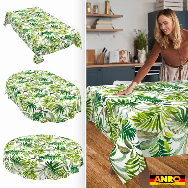 Tischdecke mit Palmblattmuster in eckiger, ovaler und runder Form. Eine Frau legt die Decke auf einen Holztisch in einer hellen Küche. ANRO Logo.