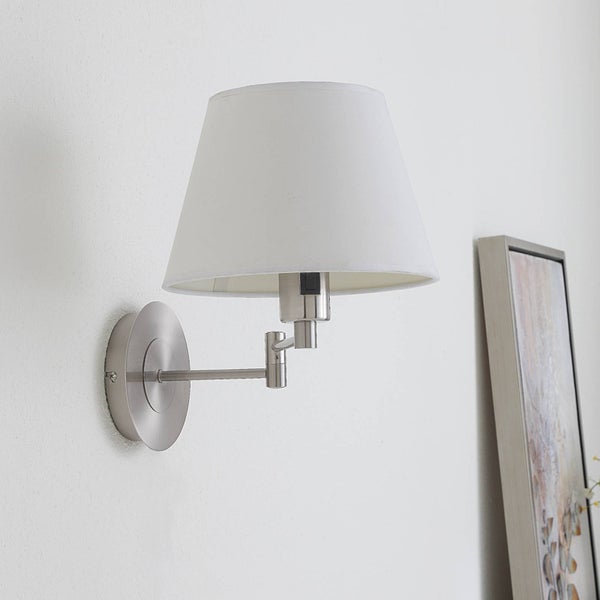 Wandleuchte mit schwenkbarem Metallarm in Nickel-Optik und weißem, konischem Stoffschirm.