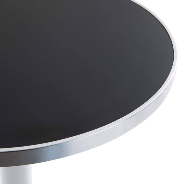 Detailansicht eines runden Bistrotischs mit schwarzer Tischplatte und gebürsteter Metallkante.