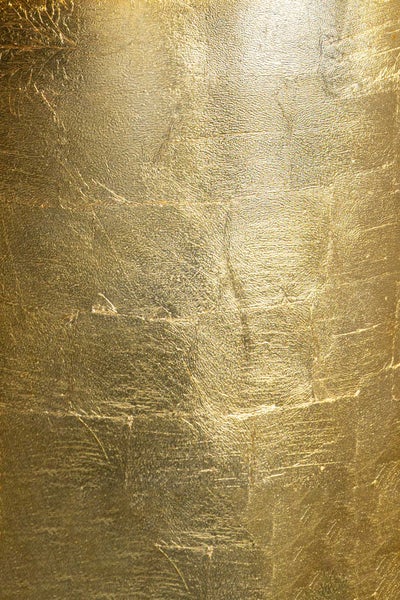 Strukturierte Oberfläche mit glänzender Goldoptik und Blattgold-Effekt.