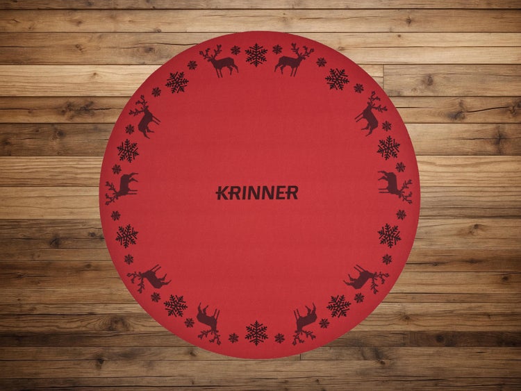 Runde rote Krinner Weihnachtsbaumunterlage mit Rentier- und Schneeflockenmuster.