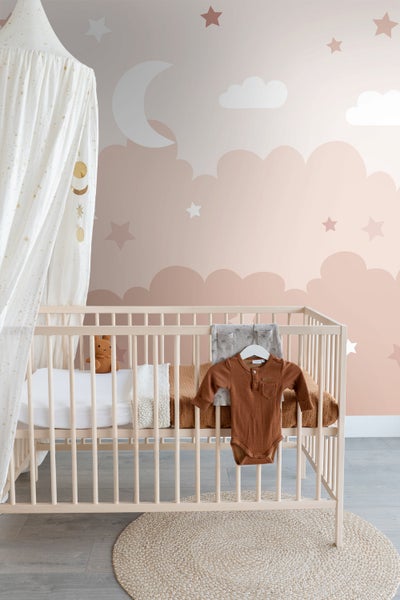 Babyzimmer mit Gitterbett, Himmelbett, Teppich und Tapete mit Wolkenmuster