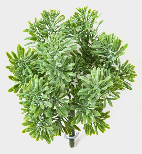 Künstliche Ranunkel aus Textilmaterial in Rosa mit grünem Stiel.