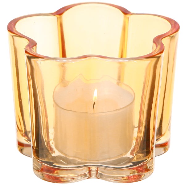 Sternförmiger Teelichthalter aus Glas mit brennender Kerze.