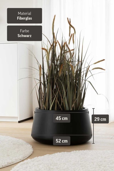 Runder Pflanzkübel aus Fiberglas in Schwarz, Höhe 29 Zentimeter, Durchmesser 45 bis 52 Zentimeter, mit dekorativen Gräsern.