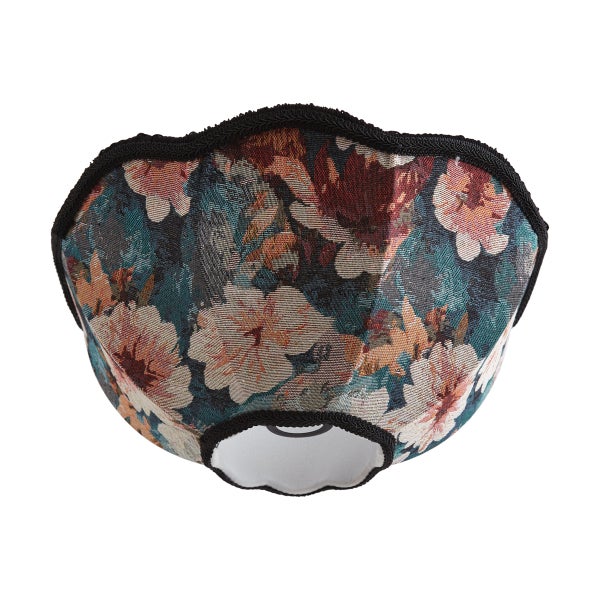 Lampenschirm aus Stoff mit floralem Gobelinmuster und schwarzer Borte an den gewellten Rändern.