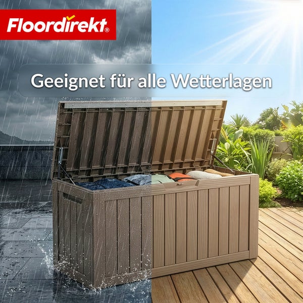 Wetterfeste Aufbewahrungsbox mit offenem Deckel auf einer Terrasse. Im Hintergrund ist eine Gartenlandschaft zu sehen. Geeignet für alle Wetterlagen.