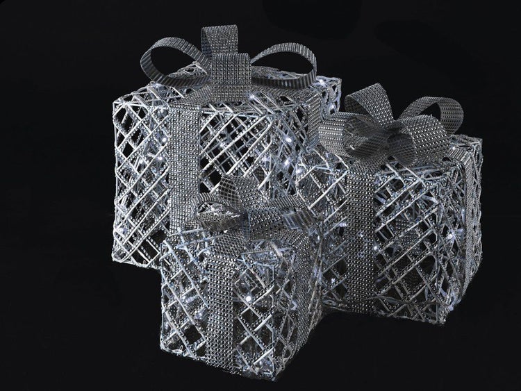 Drei quadratische Weihnachtsgeschenke aus Metallgitter mit Schleife und integrierter LED Beleuchtung als Weihnachtsdekoration.