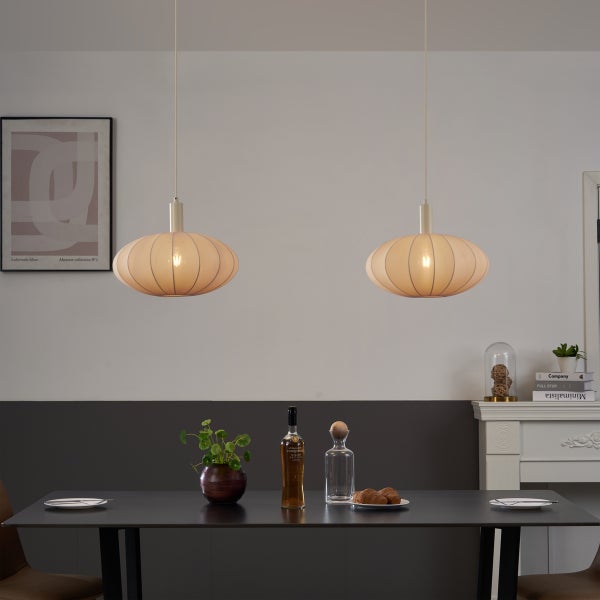 Zwei ovale Pendelleuchten mit Faltenoptik über einem dunklen Esstisch in einem modern eingerichteten Raum.