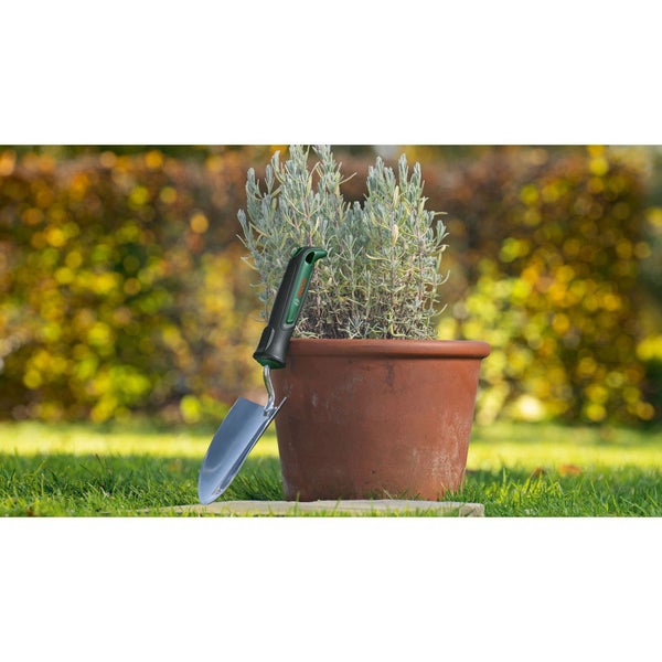 Gartenspaten mit Pflanze im Topf