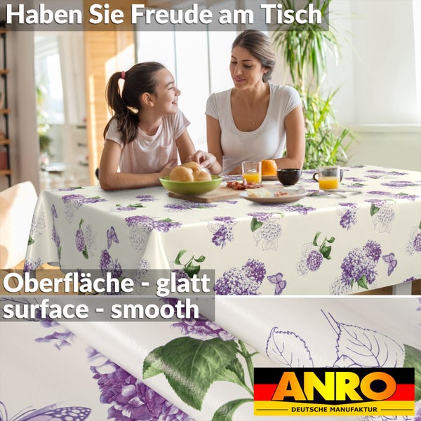 Mutter und Kind an einem Frühstückstisch mit einer Tischdecke mit lila Hortensien-Muster und glatter Oberfläche. ANRO Logo.