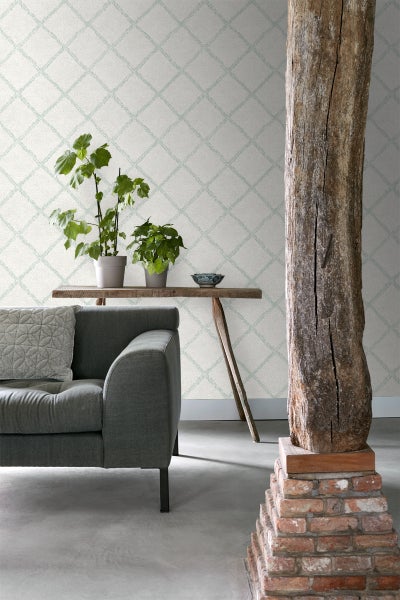 Wohnzimmer mit gemusterter Tapete, Sofa und Holzsäule