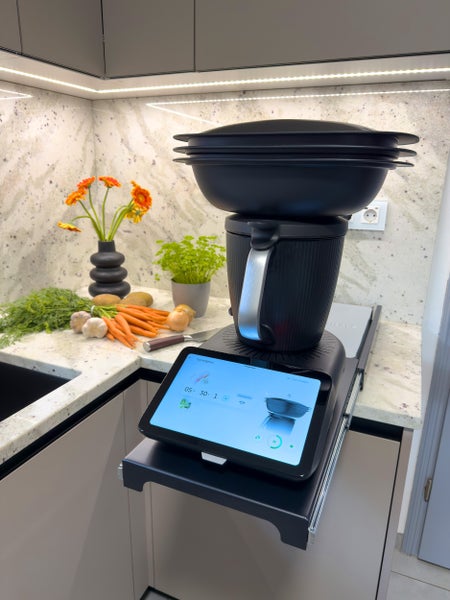 Eine moderne Küche mit einem intelligenten Küchengerät, frischen Zutaten und stilvoller Dekoration.