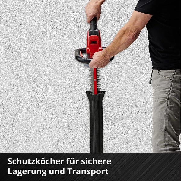 Heckenschere wird in einen wandmontierten Schutzköcher für die sichere Lagerung und den Transport gesteckt.