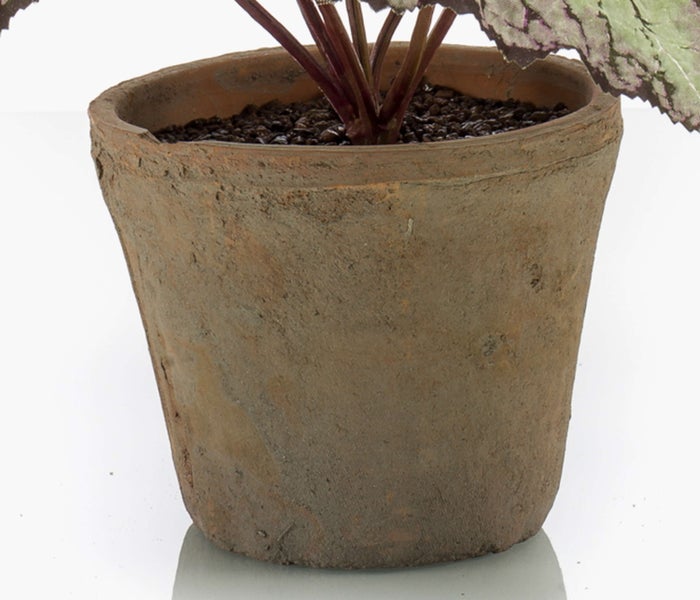 Künstliche Blume mit rosa Blüten aus Textil und kleinen grünen Knospen.