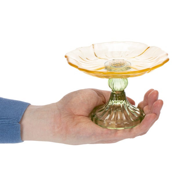 Hand hält eine dekorative Glasetagere