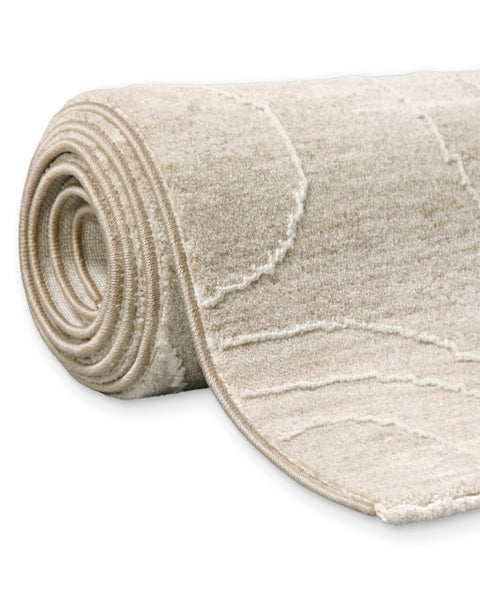 Gerollter Teppich mit Wellenmuster und strukturierter Oberfläche.