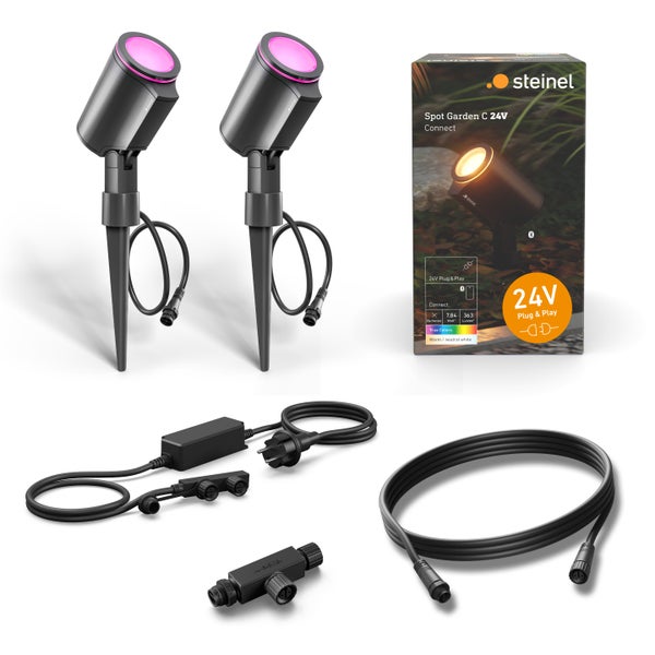 Set mit zwei Steinel Spot Garden C 24V LED Strahlern, inklusive Stromkabel, Netzteil und Verbindungsstück in der Originalverpackung.