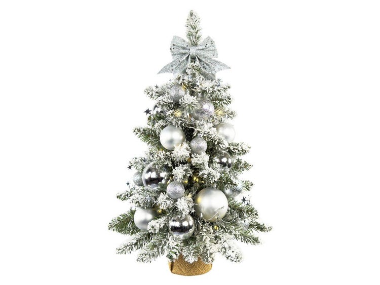Künstlicher, beschneiter Weihnachtsbaum im Topf mit Kugelschmuck und glitzernder Schleife als festliche Weihnachtsdekoration.