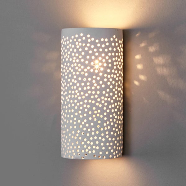 Wandleuchte mit Punktmuster beleuchtet eine Wand