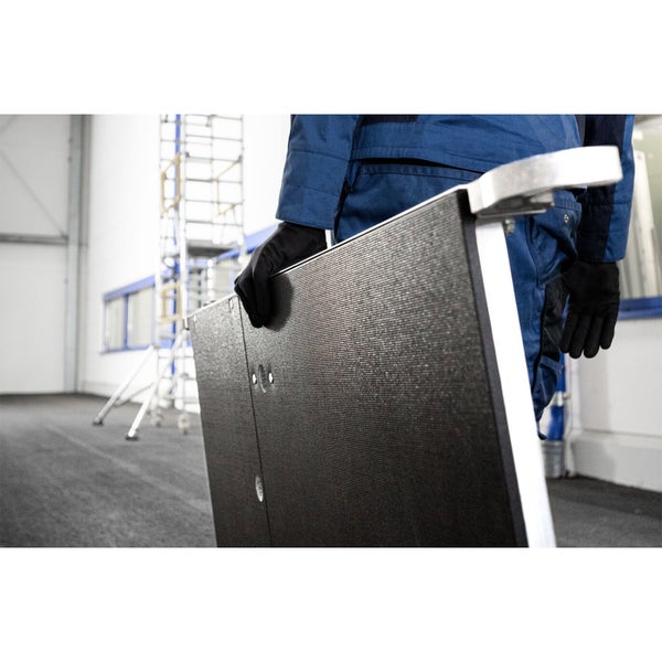 Mann mit Gerüstbauteilen und fahrbarem Gerüst