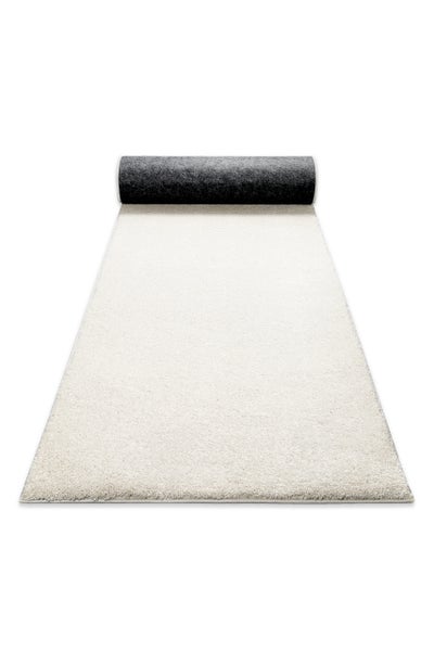 Weißer Hochflor-Läufer, weiche Textur, teilweise ausgerollt.