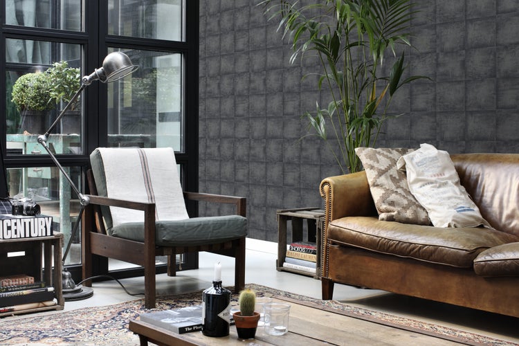 Wohnzimmer mit Sessel, Sofa, Stehlampe, Zimmerpflanze und gemusterter Tapete