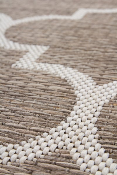 Nahaufnahme eines gewebten Teppichs mit geometrischem Muster und strukturierter Oberfläche.