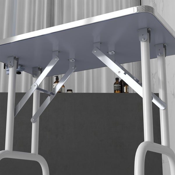 Detailansicht eines klappbaren Wandtisches mit weißem Gestell und Metallbeschlägen.