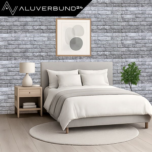 Schlafzimmer mit Wandpaneelen in Steinoptik, Bett und Nachttisch