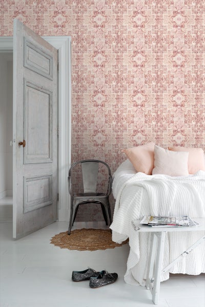 Dekoratives Zimmer mit gemusterter Tapete, Bett und Stuhl