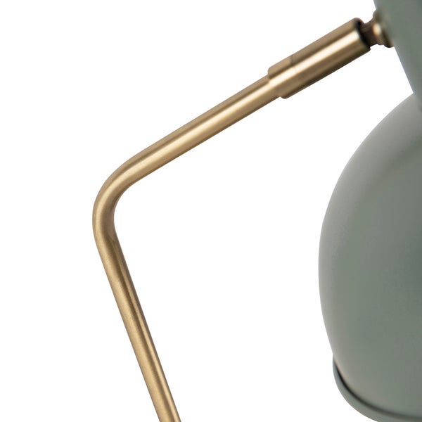 Detailaufnahme einer grauen Lampe mit goldenem Gestell
