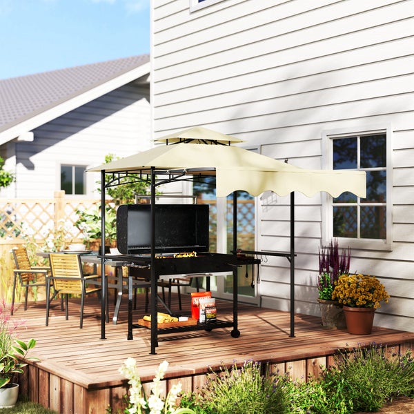 Grillpavillon mit beigem Doppeldach und Seitenmarkise auf einer Holzterrasse neben einem Haus, inklusive schwarzem Grill.
