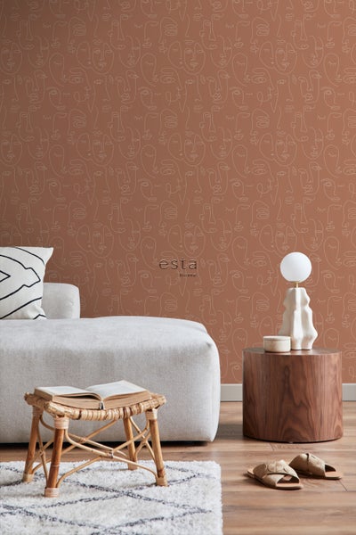 Wohnraumszene mit einem Sofa, einem Hocker, einem Holztisch und einer Wand mit Gesichtstapete.