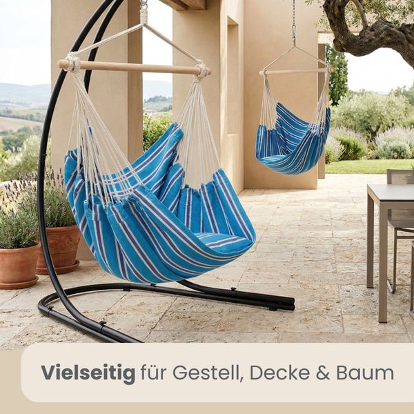 Gestreifte Hängesessel auf einer Terrasse, vielseitig nutzbar an einem Metallgestell oder hängend an der Decke oder einem Baum.