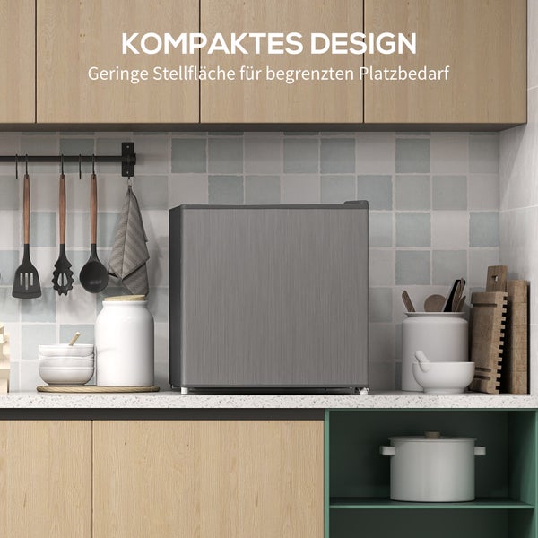 Kompakter Minikühlschrank in Edelstahloptik auf einer Küchenarbeitsplatte, platzsparendes Design für kleine Küchen.