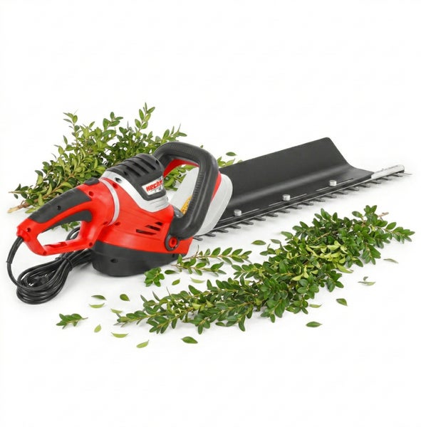 Elektrische Heckenschere mit Kabel und Heckenmaterial