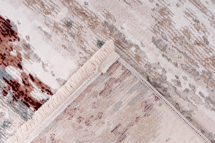 Teppich mit abstraktem Muster, Fransen an der Kante und Detailansicht der Rückseite.