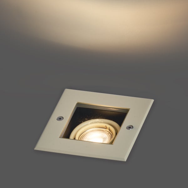 Quadratischer Bodeneinbaustrahler mit eingeschalteter Lichtquelle und nach oben gerichtetem Lichtkegel.