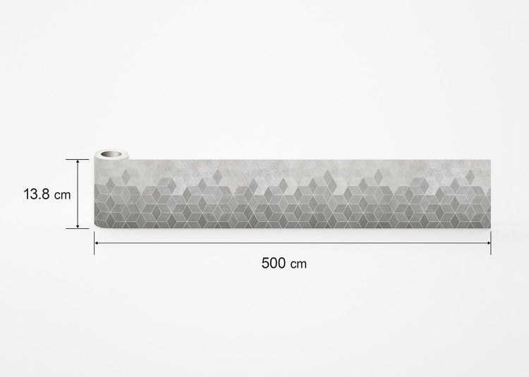Graue Wandfliese mit geometrischem Rautenmuster in Betonoptik.